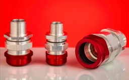 Conectores TMCX metálicos con base roja para instalaciones eléctricas industriales.